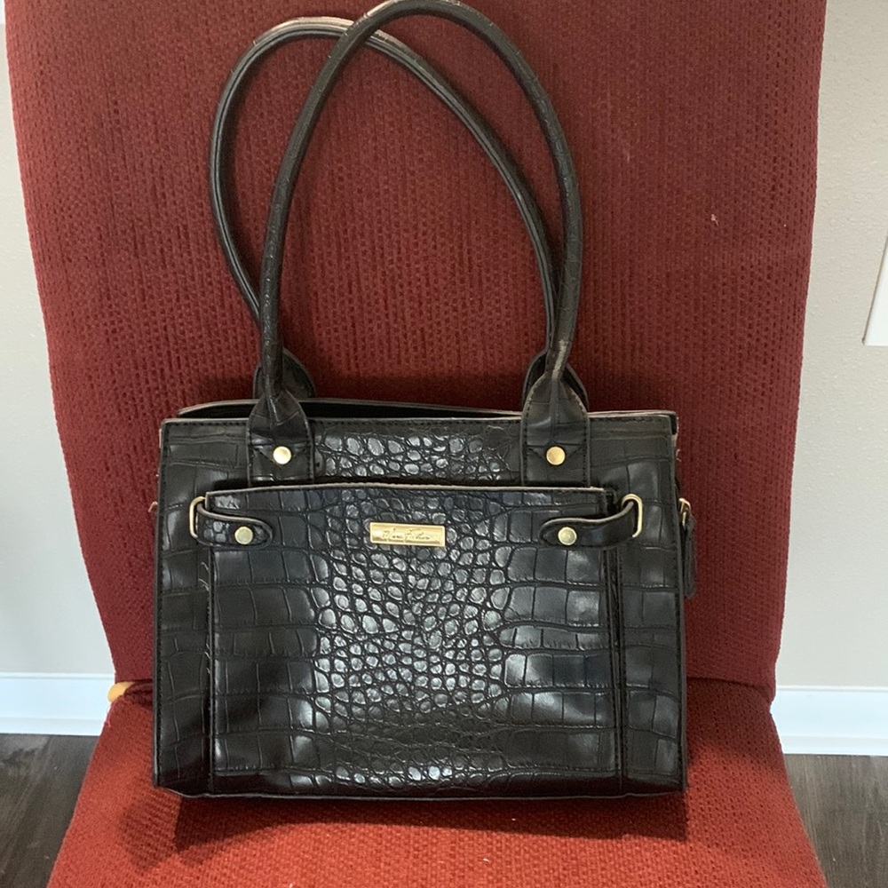 Faux snakeskin purse with front pocket and gold highlights.